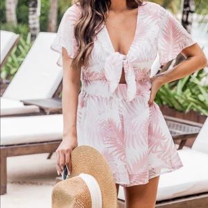 Pink Lily Women’s fuchsia romper with tie in front.  Size medium.